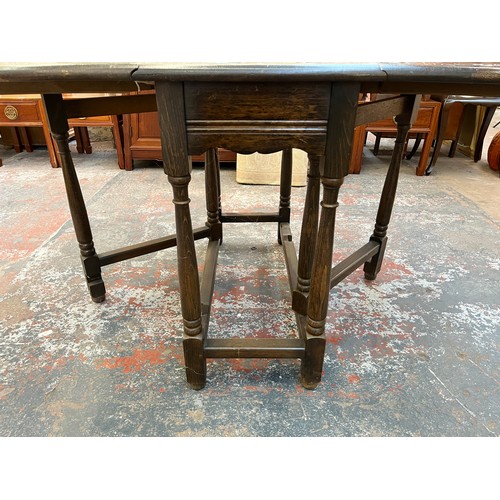 186 - A mid 20th century carved oak drop leaf gate leg dining table - approx. 75cm high x 91cm wide x 153c... 
