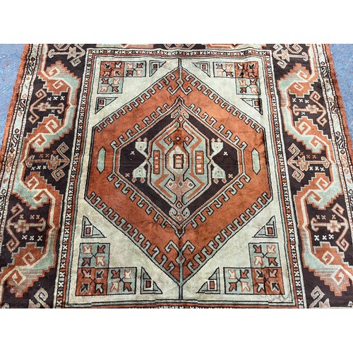166 - A mid 20th century orange machine woven rug - approx. 184cm x 138cm