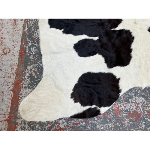 178 - A cow hide rug - approx. 236cm x 190cm