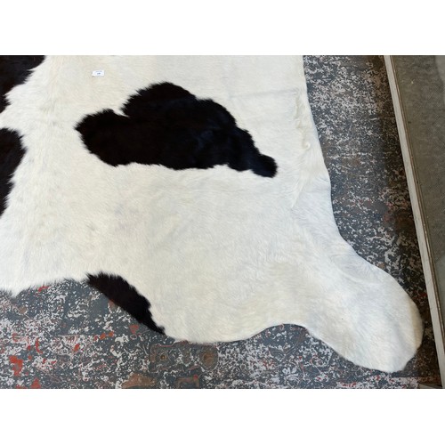 178 - A cow hide rug - approx. 236cm x 190cm