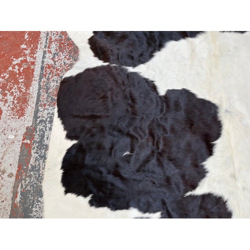 178 - A cow hide rug - approx. 236cm x 190cm