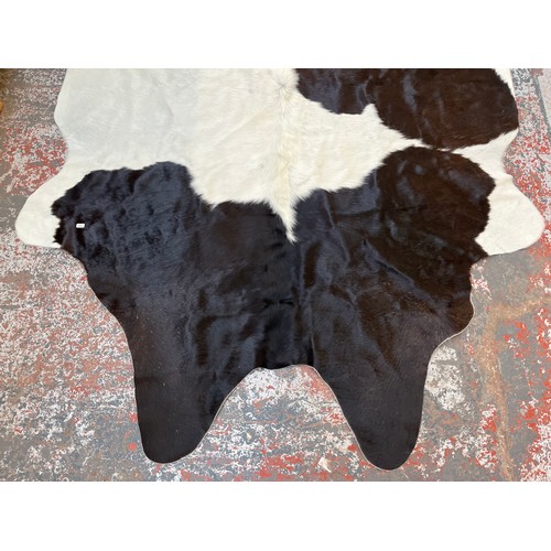 178 - A cow hide rug - approx. 236cm x 190cm