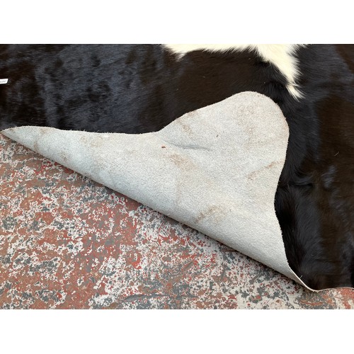 178 - A cow hide rug - approx. 236cm x 190cm