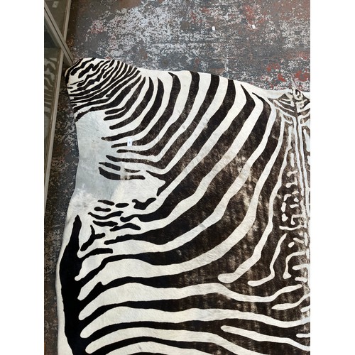 183 - A zebra hide rug - approx. 210cm x 212cm