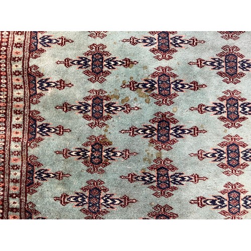 211 - A late 20th century Bokhara turquoise machine woven rug - approx. 193cm x 129cm