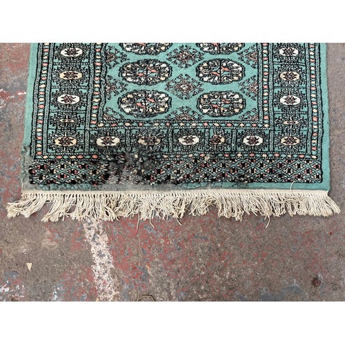 202 - A mid/late 20th century Bokhara turquoise rug - approx. 127cm x 85cm