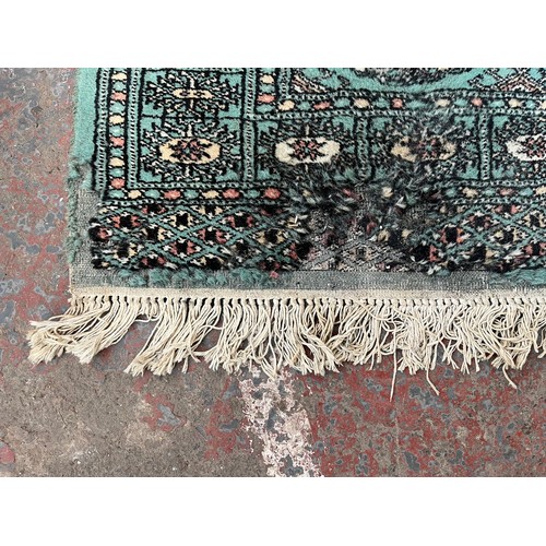 202 - A mid/late 20th century Bokhara turquoise rug - approx. 127cm x 85cm