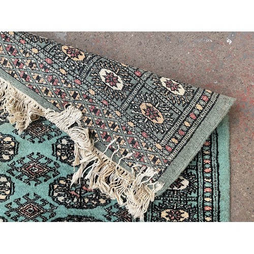 202 - A mid/late 20th century Bokhara turquoise rug - approx. 127cm x 85cm