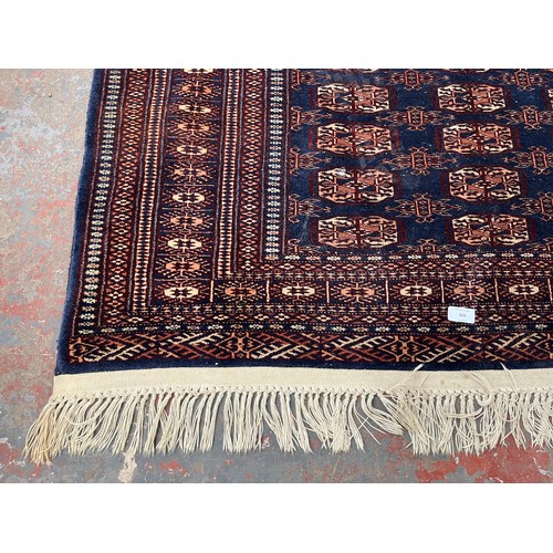 204 - A mid/late 20th century Bokhara blue rug - approx. 185cm x 126cm