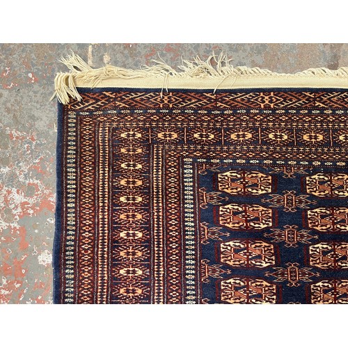 204 - A mid/late 20th century Bokhara blue rug - approx. 185cm x 126cm