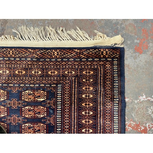 204 - A mid/late 20th century Bokhara blue rug - approx. 185cm x 126cm