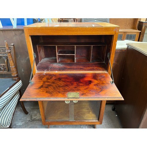 93 - A mid 20th century plywood bureau bookcase with glass sliding doors