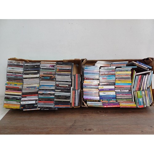 660 - Two boxes containing a large collection of CDs to include Finn, Foo Fighters, Cosmic Rough Riders, P... 