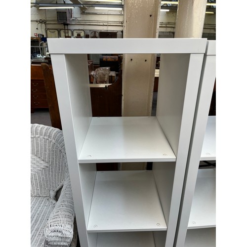 203 - A pair of IKEA Kallax white laminate shelving units - approx. 148cm high x 41cm wide x 39cm deep