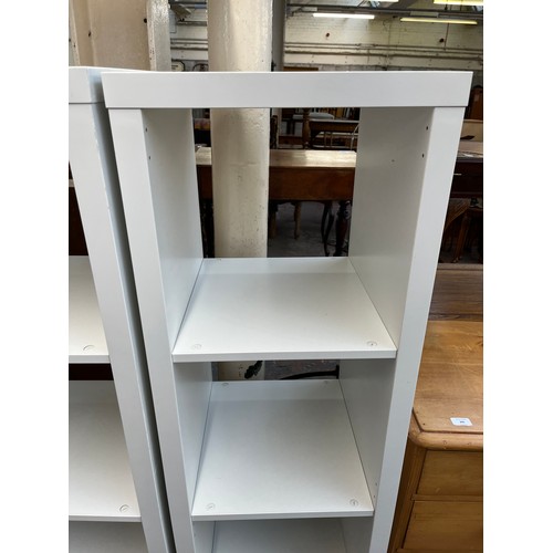 203 - A pair of IKEA Kallax white laminate shelving units - approx. 148cm high x 41cm wide x 39cm deep