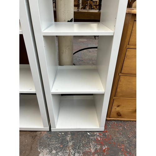 203 - A pair of IKEA Kallax white laminate shelving units - approx. 148cm high x 41cm wide x 39cm deep