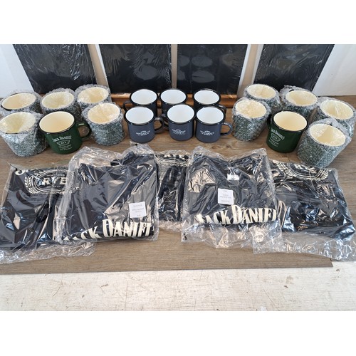 890 - Three boxes containing Jack Daniels memorabilia comprising eighteen enamel mugs, five t-shirts and c... 