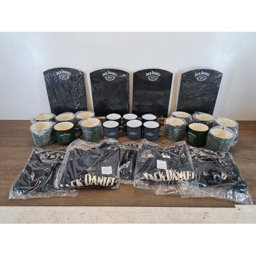 894 - Three boxes containing Jack Daniels memorabilia comprising eighteen enamel mugs, five t-shirts and c... 