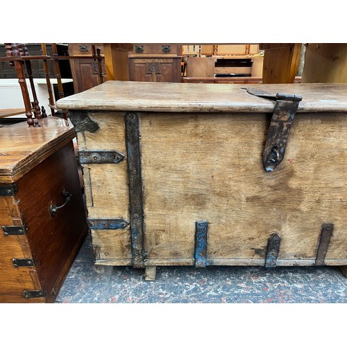 214 - A 19th century teak and metal banded marriage chest - approx. 57cm high x 104cm wide x 48cm deep