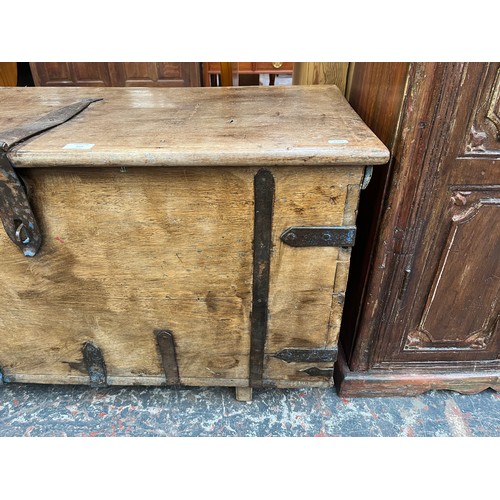 214 - A 19th century teak and metal banded marriage chest - approx. 57cm high x 104cm wide x 48cm deep