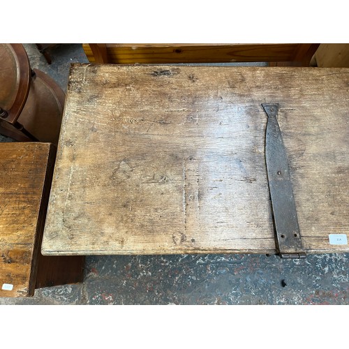 214 - A 19th century teak and metal banded marriage chest - approx. 57cm high x 104cm wide x 48cm deep