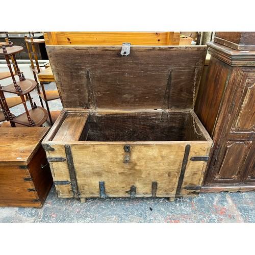 214 - A 19th century teak and metal banded marriage chest - approx. 57cm high x 104cm wide x 48cm deep