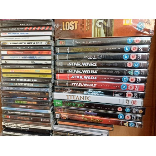 667 - A collection of sealed DVDs and unsealed CDs to include Pink Floyd, Oasis, Pearl Jam, The Prodigy, R... 