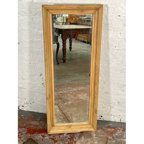 217 - A distressed pine framed wall mirror - approx. 116cm high x 46cm wide