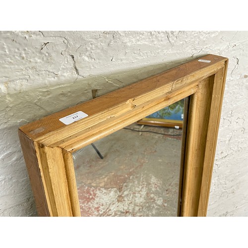 217 - A distressed pine framed wall mirror - approx. 116cm high x 46cm wide