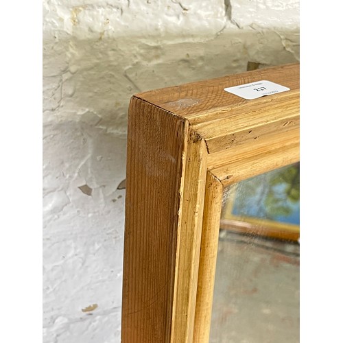 217 - A distressed pine framed wall mirror - approx. 116cm high x 46cm wide