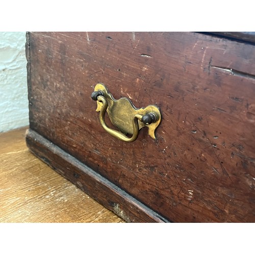 215 - A 19th century stained pine box with brass escutcheon and handles - approx. 20cm high x 64cm wide x ... 