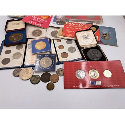 2214 - A collection of commemorative coins and medallions to include packaged 1981 Isle of Man proof £5, 20... 