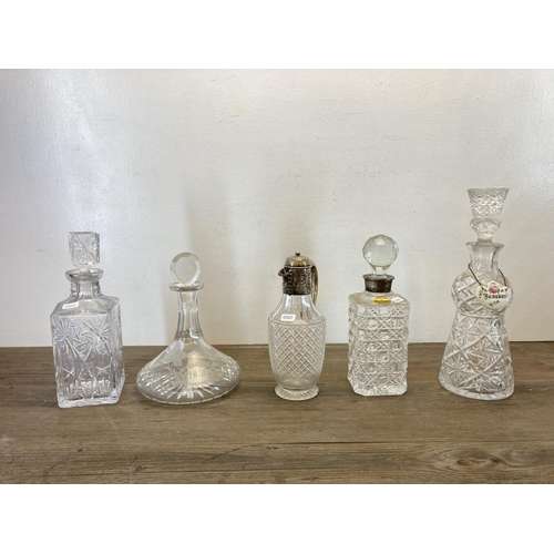 437 - Five pieces of cut glassware, one silver plated claret jug and four decanters to include Royal Brier... 