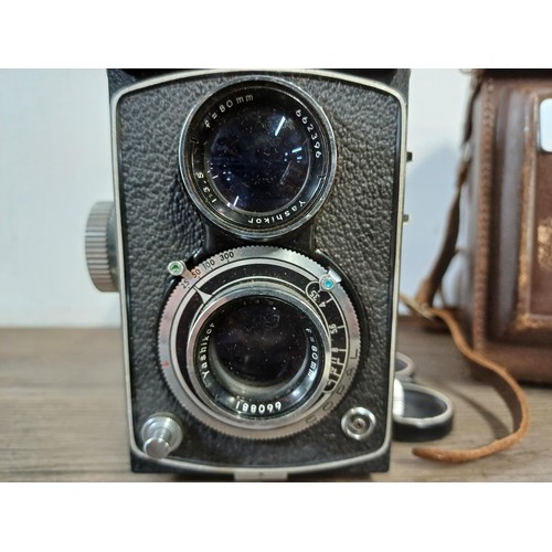 679 - A cased Yashica-A 6 x 6 medium format TLR camera fitted with Yashikor 1:3.5 f=80mm lenses and Copal ... 