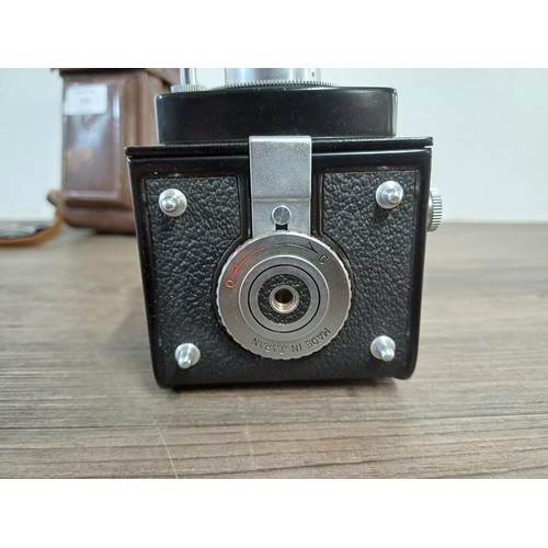 679 - A cased Yashica-A 6 x 6 medium format TLR camera fitted with Yashikor 1:3.5 f=80mm lenses and Copal ... 