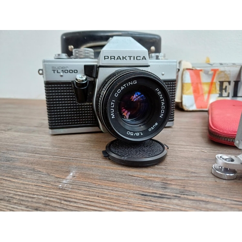 696 - Six items to include Pentacon Praktica Super TL1000 35mm SLR camera fitted with 1.8/50 lens, Canon E... 