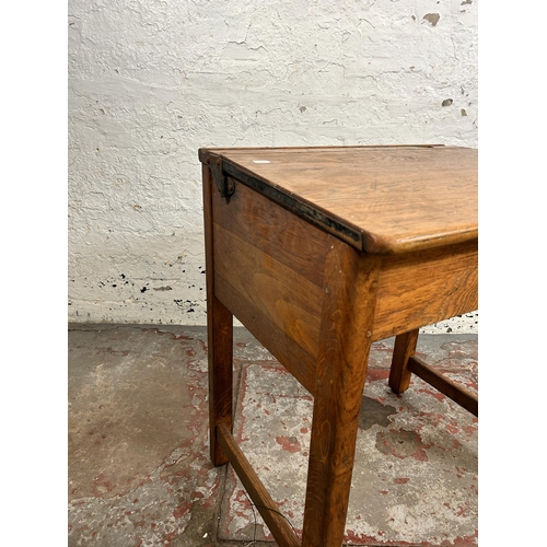 42 - A mid 20th century oak school desk - approx. 70cm high x 62cm wide x 46cm deep