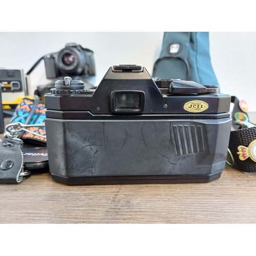 693 - A collection of cameras to include Zenit EM 35mm SLR fitted with Helios-44M 2/58 lens, cased Minolta... 