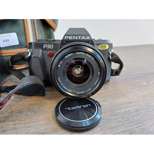 694 - A Miranda camera bag containing Pentax P30 35mm SLR fitted with Sigma super-wide II 1:2.8 f=24mm len... 