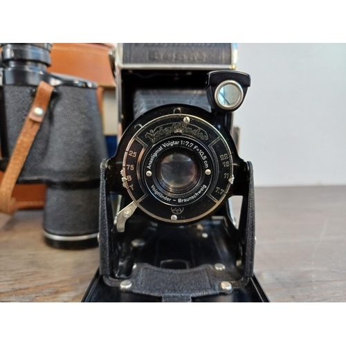 697 - Three items, one mid 20th cetury Voigtländer Bessa 6 x 9cm medium format folding camera for 120 film... 