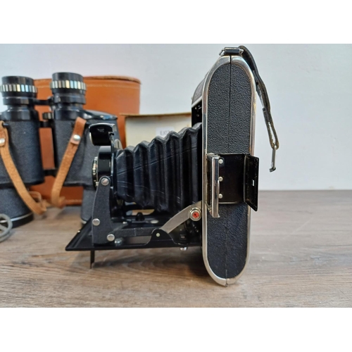 697 - Three items, one mid 20th cetury Voigtländer Bessa 6 x 9cm medium format folding camera for 120 film... 