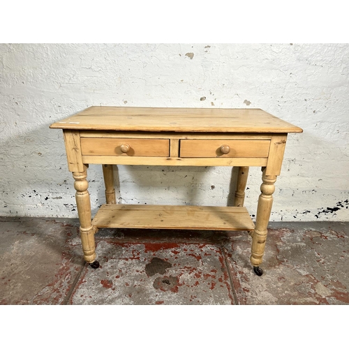 99 - A Victorian pine two drawer wash stand/console table - approx. 73cm high x 95cm wide x 52cm deep