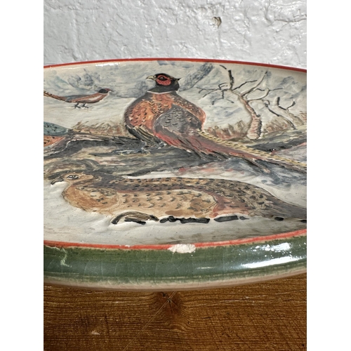 308 - A 1994 Rodney George pheasant scene hand painted studio pottery wall charger - approx. 39cm diameter