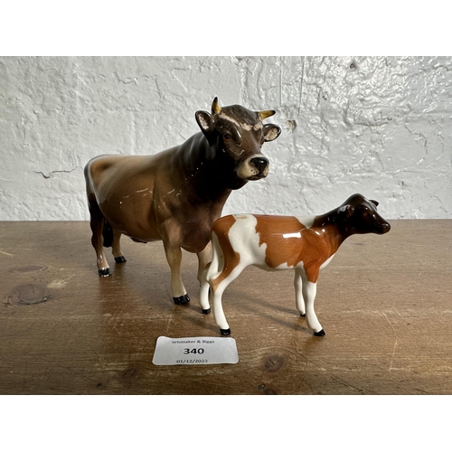 340 - Two Beswick cattle figurines, CH. Dunsley Coy Boy Jersey Bull - no. 1422 and Guernsey Calf - no. 124... 