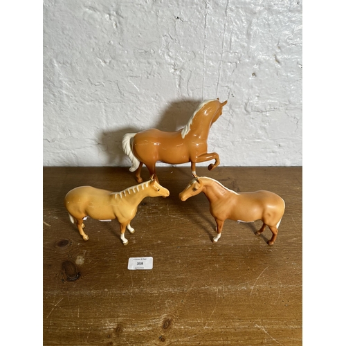 359 - Three Beswick Palomino horse figurines to include Head Tucked Leg Up no. 1549 etc.