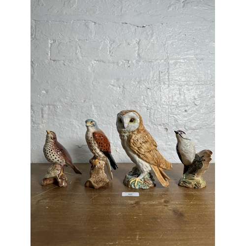 369 - Four Beswick bird figurines, Lesser Spotted Woodpecker no. 2420, Kestrel no. 2316, Songthrush no. 23... 