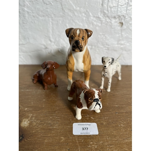 377 - Four Beswick dog figurines, Boxer Blue Mountain Greta no. 1202, Dachshund no. 1460, Dalmatian no. 17... 