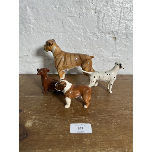 377 - Four Beswick dog figurines, Boxer Blue Mountain Greta no. 1202, Dachshund no. 1460, Dalmatian no. 17... 