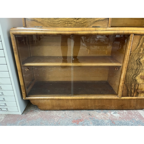 180 - A mid 20th century Art Deco style Rurka walnut drinks cabinet with two glass sliding doors and fall ... 