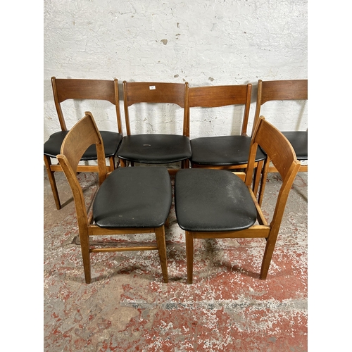 101 - Six mid 20th century teak and black vinyl dining chairs